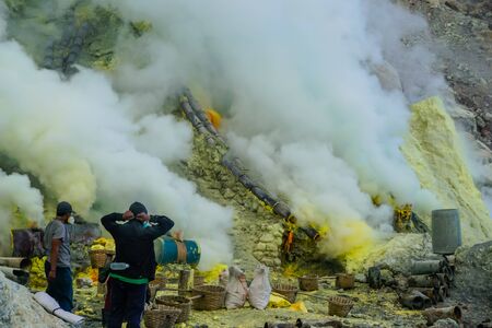 Ijen Volcano, Indonesia - April 1, 2018: Workers mine sulfur from the crater of the volcanoのeditorial素材