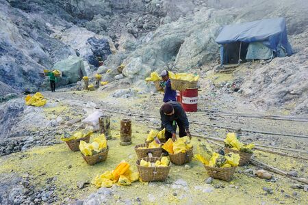 Ijen Volcano, Indonesia - April 1, 2018: Workers mine sulfur from the crater of the volcanoのeditorial素材