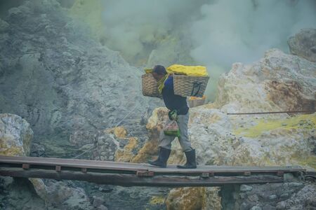 Ijen Volcano, Indonesia - April 1, 2018: Workers mine sulfur from the crater of the volcanoのeditorial素材