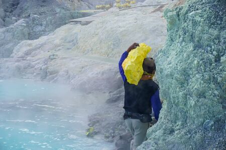 Ijen Volcano, Indonesia - April 1, 2018: Workers mine sulfur from the crater of the volcanoのeditorial素材