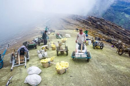 Ijen Volcano, Indonesia - April 1, 2018: Workers mine sulfur from the crater of the volcanoのeditorial素材