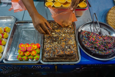 Kuala Terengganu, Malaysia - April 4, 2019: Sweets on the counter of street food marketのeditorial素材