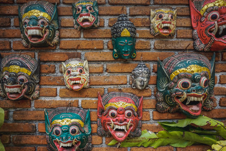 Balinese hindu masks on brick wallの写真素材