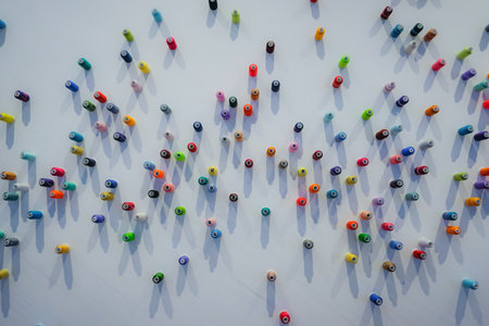 Many multi-colored skeins of thread on a white wallの写真素材