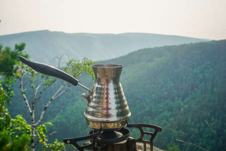 Brewing fresh coffee in a Turk in natureの写真素材