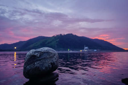 Stone on the quiet water surface of the Yenisei Riverの写真素材