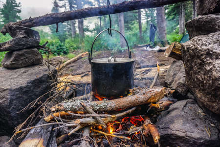 Cooking in a pot over a fire in the taigaの写真素材