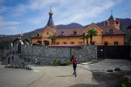 Dagomys, Russia - March 23, 2020: Girl tourist at the Orthodox church