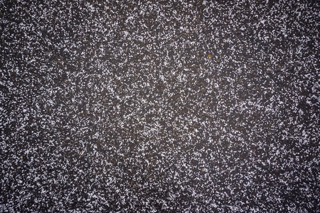 Snow crumbs on paving slabs, backgroundの写真素材