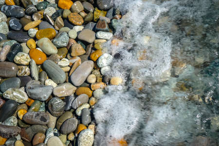 Multi colored pebbles on the beachの写真素材