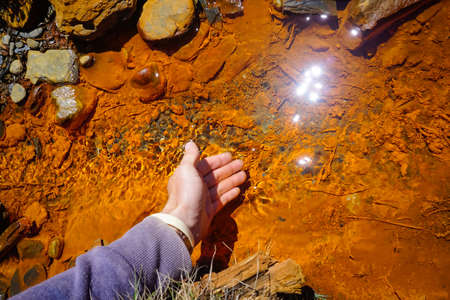 Orange water of the Narzan spring in the Caucasus mountains