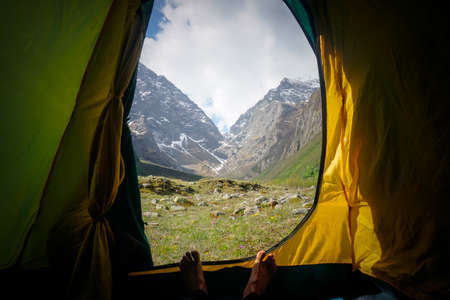 View from the tent to the snowy mountainsの写真素材