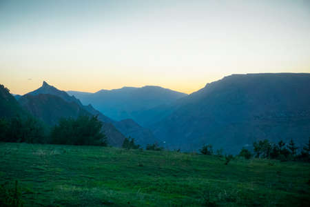 Beautiful sunset over a green valley in Caucasus mountains in Dagestan