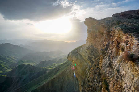 Sheer cliff of the mountain range at sunset in Dagestanの写真素材