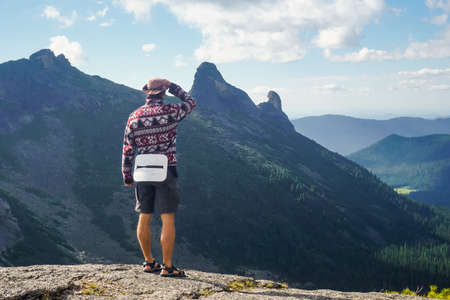 Hiker on a mountain cliff in Ergaki nature reserve, Russia