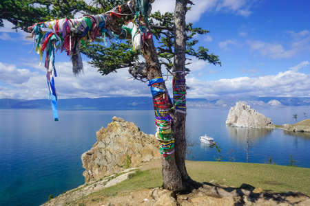 Tree with colored ribbons off the coast of Olkhon Island in Baikal