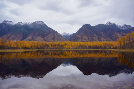 Mountain lake in the taiga and Kodar ridge in Trans Baikal territoryの写真素材