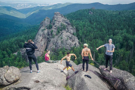 Krasnoyarsk, Russia - July 12, 2020: Guys climb the rocks of the Krasnoyarsk Pillarsのeditorial素材