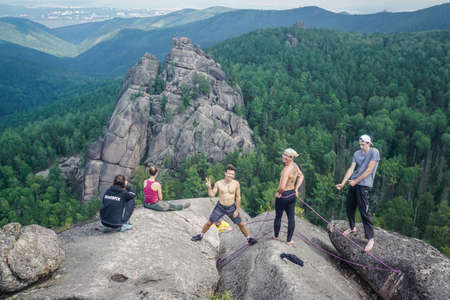 Krasnoyarsk, Russia - July 12, 2020: Guys climb the rocks of the Krasnoyarsk Pillarsのeditorial素材