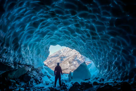 man inside an ice caveの写真素材