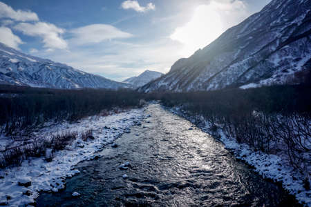Mountain river and winter landscape in Kamchatka peninsula in Russiaの写真素材