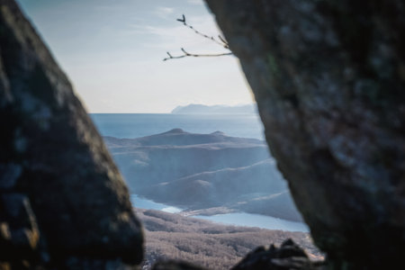 View of the Pacific Ocean through the rocks in Kamchatkaの写真素材