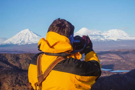 The guy takes pictures of volcanoes in Kamchatka peninsula in Russiaの写真素材