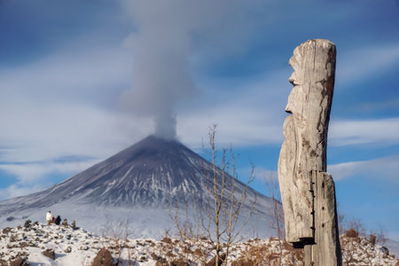 Wooden totem next to the volcanoの写真素材