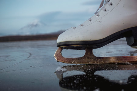 Ice Skates on a Frozen Lake in Kamchatka at sunsetの写真素材