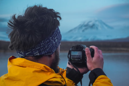 A Man Taking Photos of Volcanoes at sunset in Kamchatkaの写真素材