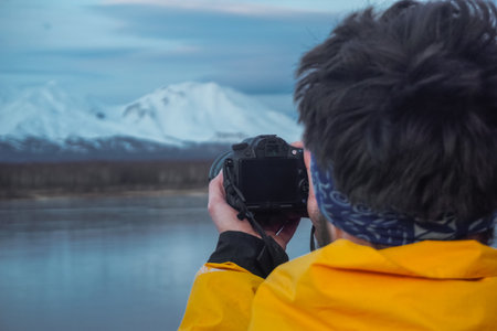 A Man Taking Photos of Volcanoes at sunset in Kamchatkaの写真素材
