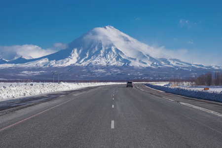 Road and view to Koryaksky Volcano in Kamchatka peninsula in Russiaの写真素材