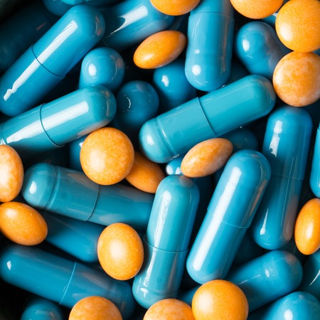 Blue medical pills and capsules pattern on white background. flat lay, top viewの写真素材