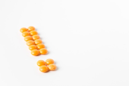 exclamation mark shape made of color pills.の写真素材