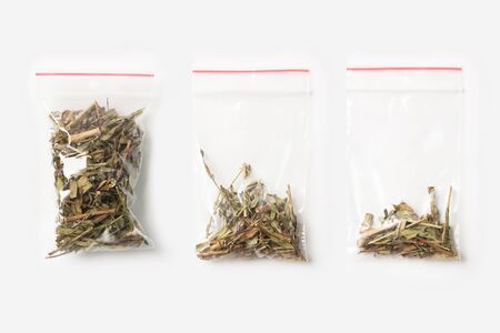 Set of three EMPTY, HALF AND FULL Plastic transparent zipper bag with blooming Sally tea isolated on white. Vacuum package mockup with red clip. Conceptの写真素材
