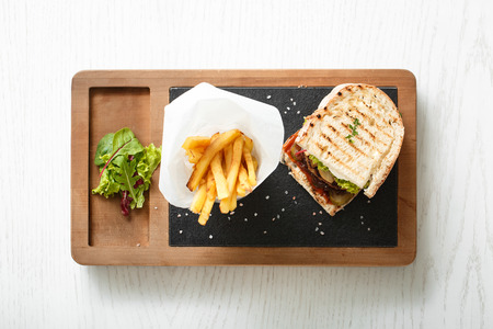 Top view of toast with fried bacon and potatoes. Sandwich with fried bacon and fried potatoes on...