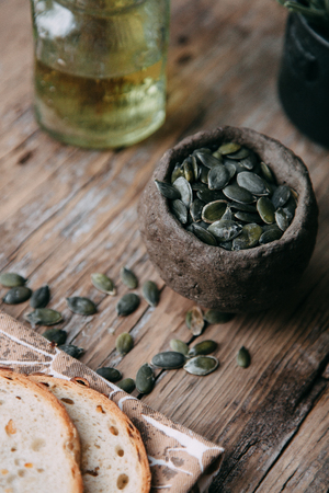 Sliced bread with butter on wooden background and the scattered seeds.の写真素材