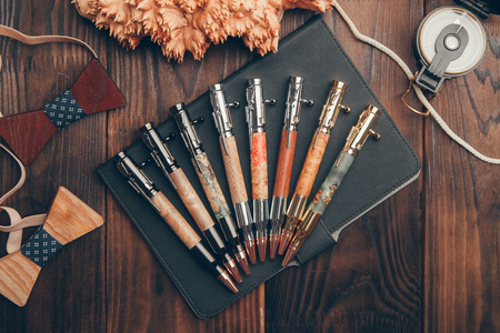 expensive pens business class for entrepreneurs, on wooden backgroundの写真素材