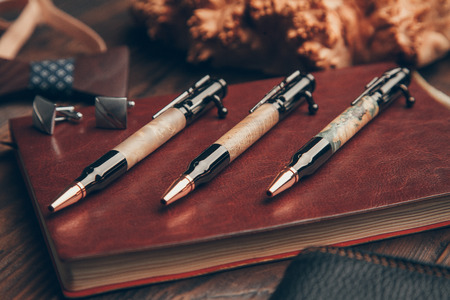 expensive pens business class for entrepreneurs, on wooden backgroundの写真素材