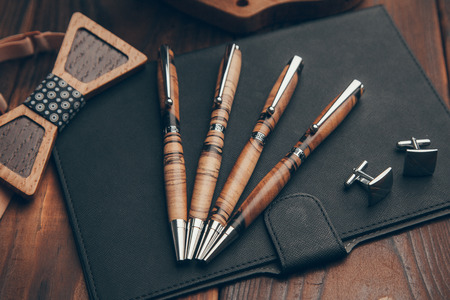 expensive pens business class for entrepreneurs, on wooden backgroundの写真素材
