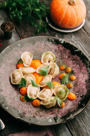 dumplings with potatoes, cheese, berries, compositions for the menu of the restaurant, decorated with greens and sauceの写真素材