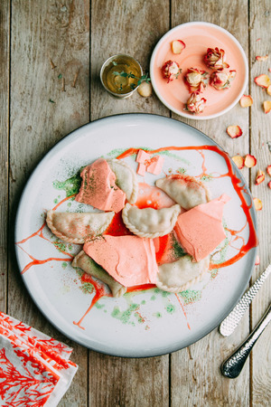 dumplings with potatoes, cheese, berries, compositions for the menu of the restaurant, decorated with greens and sauceの写真素材