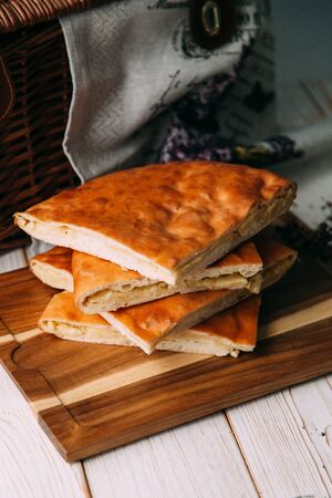homemade pastries with fillings of potatoes, cabbage and fish, in the composition on a textured backgroundの写真素材