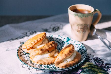 homemade pastries with fillings of potatoes, cabbage and fish, in the composition on a textured backgroundの写真素材