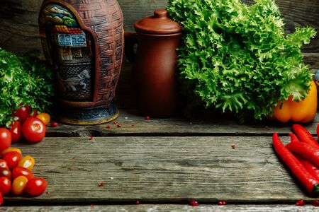 Ripe fresh vegetables on a wooden table. Background of vegetables with an empty space in the middle.の写真素材