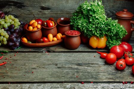 Ripe fresh vegetables on a wooden table. Background of vegetables with an empty space in the middle.の写真素材