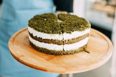 Green natural spinach cake, vegan. Layer cake with spinach and cream. の写真素材
