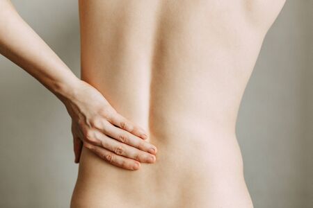 Injuries to the spine and lower back, fatigue at work. Area of the injury, the image on a clean background. Spasm on the man's back.の写真素材