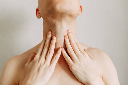 Injuries of the spine and throat, fatigue on the job. Area of the injury, the image on a clean background. Spasm on the man's neck.の写真素材