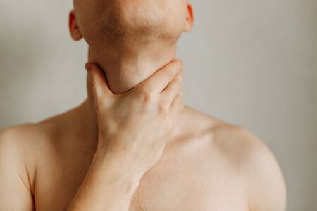 Injuries of the spine and throat, fatigue on the job. Area of the injury, the image on a clean background. Spasm on the man's neck.の写真素材